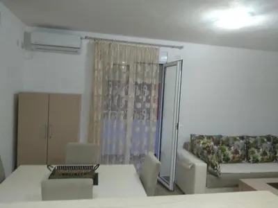 a living room with a couch and a table at Guesthouse Marko in Becici