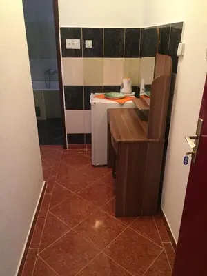 a bathroom with a desk and a sink in a room at Guesthouse Marko in Becici