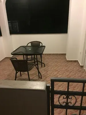 a table and two chairs in a room at Guesthouse Marko in Becici