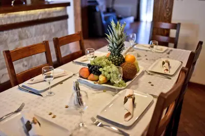 a table with a plate of fruit on it at Villa Dub in Kotor