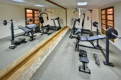 a gym with several tread machines and weights at Villa Dub in Kotor