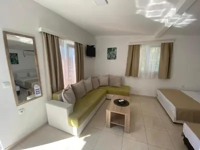 a living room with a couch and a bed at Apartments Vila Sara M in Ulcinj