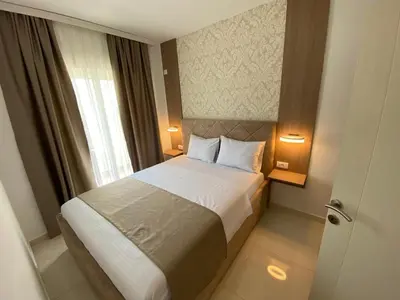 a bed in a hotel room with a window at Apartments Vila Sara M in Ulcinj