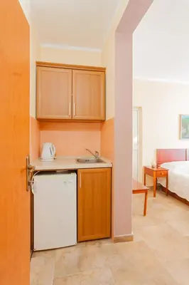 a kitchen with a sink and a bed in a room at Vongola in Utjeha