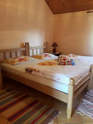 a large bed with a wooden frame in a bedroom at House Stijepovic in Petrovac na Moru