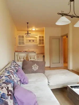 a living room with a white couch and purple pillows at Apartments City Life in Podgorica