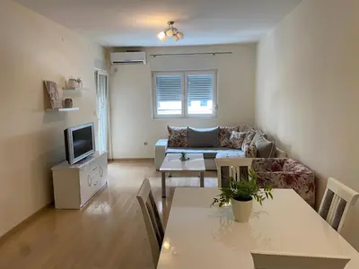 a living room with a couch and a table at Apartments City Life in Podgorica