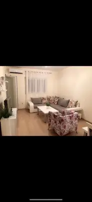 a living room with two couches and a table at Apartments City Life in Podgorica