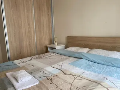a bed with two towels sitting on top of it at Apartments City Life in Podgorica