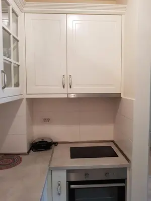a kitchen with white cabinets and a sink at Apartments City Life in Podgorica