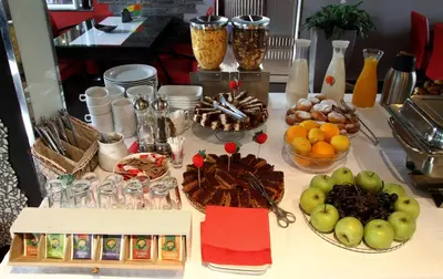 a table with fruits and other food on it at Hotel Aruba in Budva
