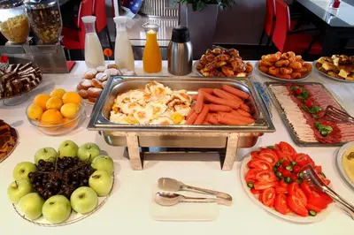 a table topped with a buffet of fruits and vegetables at Hotel Aruba in Budva