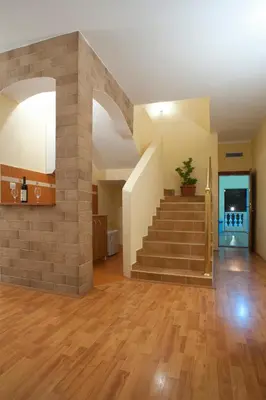 a living room with a staircase in a house at Castellamare Residence in Petrovac na Moru
