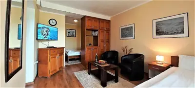 a room with a bedroom with a bed and a desk at Castellamare Residence in Petrovac na Moru