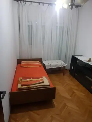 a bedroom with a bed and a desk and a bed sidx sidx sidx at Holiday Home Celuga in Bar