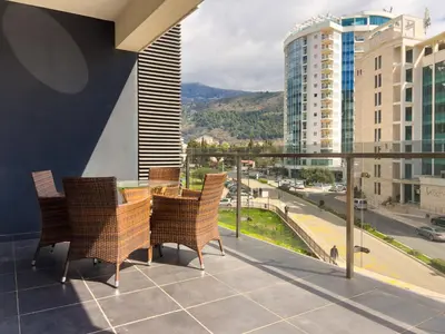 a balcony with a table and chairs on a balcony at Sea View Apartments Perovic in Budva