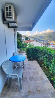 a blue table and a chair on a patio at Apartmani Cupic in Budva