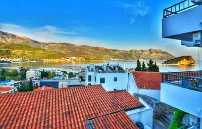 a view of a river from a city with buildings at Apartmani Cupic in Budva