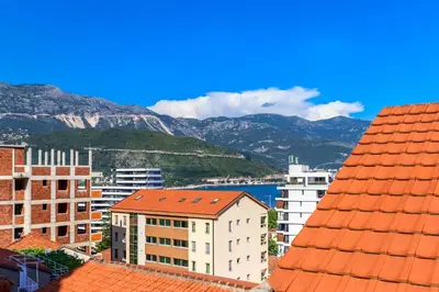 a view of a city with buildings and mountains at Apartment Mario in Budva