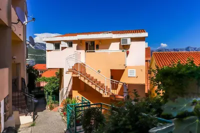 a building with stairs and orange roofs at Apartment Mario in Budva
