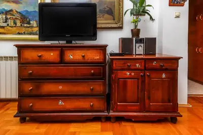 a wooden dresser with a tv on top of it at Apartment Mario in Budva