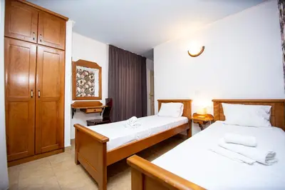 a bedroom with two beds and a cabinet at Tanja Apartments in Rafailovici
