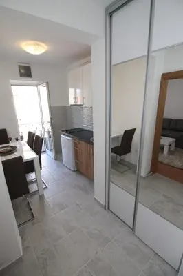 a room with a kitchen and a dining room with a table at Luxury Apartment Stefan in Sveti Stefan