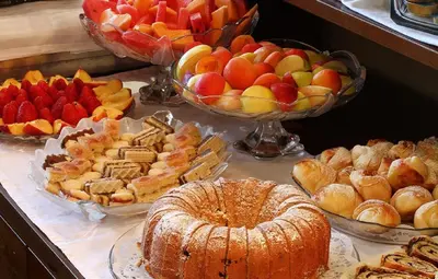 a buffet of different types of desserts and pies at Hotel Bella Vista in Budva