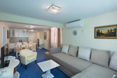 a living room with a couch and a kitchen at Hotel Bella Vista in Budva
