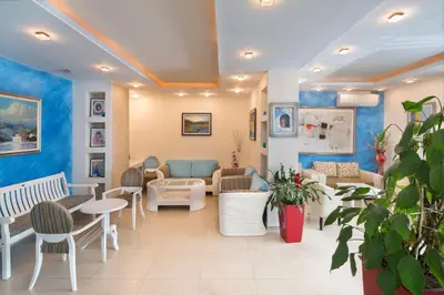 a waiting room at a hospital with tables and chairs at Hotel Bella Vista in Budva