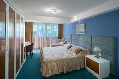 a bedroom with a bed and a desk in it at Hotel Bella Vista in Budva