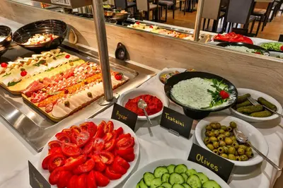 a buffet with many different types of food on a table at Hotel Harmony by Aycon in Petrovac na Moru