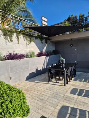 a black table and chairs on a patio at Apartments Merin in Utjeha