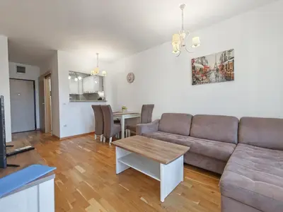 a living room with a couch and a table at Andrey Apartment in Budva