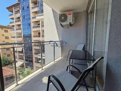a balcony with two chairs and a air conditioner at Andrey Apartment in Budva