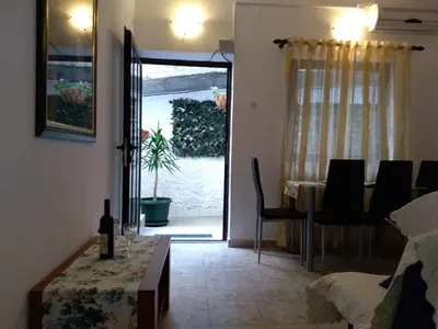 a dining room with a table and a dining room at Guest house Villa Castio in Petrovac na Moru