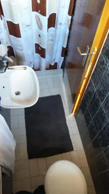 a bathroom with a sink and a toilet and a shower at Guest house Villa Castio in Petrovac na Moru