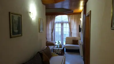 a living room with a couch and a chair at Guest house Villa Castio in Petrovac na Moru