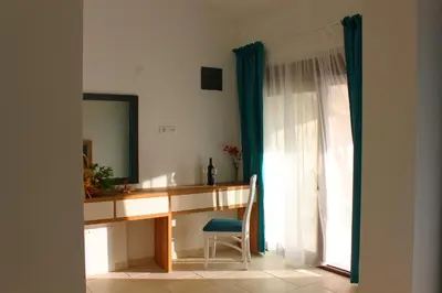 a desk with a mirror and a chair next to a window at Luka Villa in Becici
