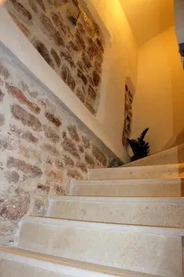 a staircase in a building with a brick wall at Luka Villa in Becici