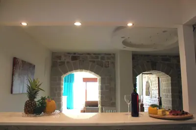 a kitchen with a counter with fruits and wine bottles at Luka Villa in Becici