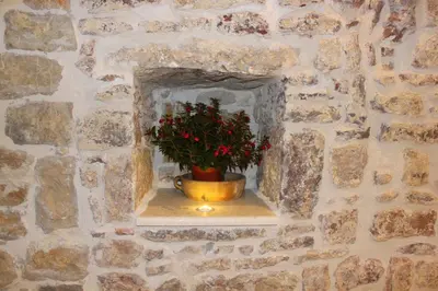 a stone wall with a pot with a plant in it at Luka Villa in Becici