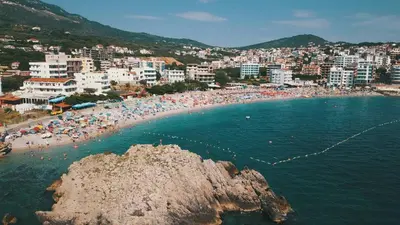 a beach with a bunch of people in the water at Apartment Melina in Dobra Voda