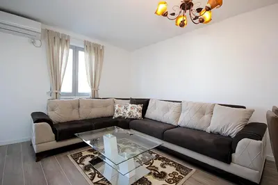 a living room with a couch and a glass table at Apartment Melina in Dobra Voda