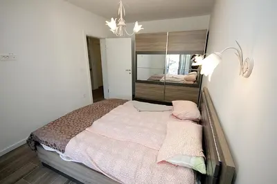 a bedroom with a bed with a mirror on the wall at Apartment Melina in Dobra Voda