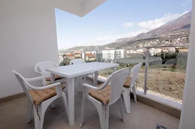 a white table and chairs on a balcony with a view at Apartment Melina in Dobra Voda