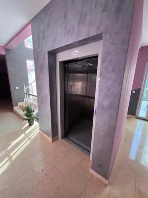 an elevator in a building with a concrete wall at Anja Apartment in Rafailovici