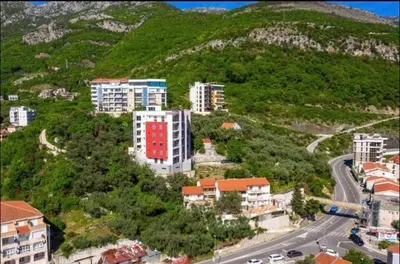 an aerial view of a city with buildings and a road at Anja Apartment in Rafailovici