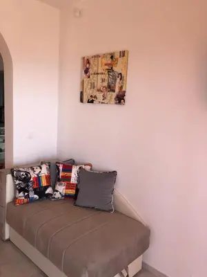 a couch with pillows on it in a room at Vila POGLED in Bar