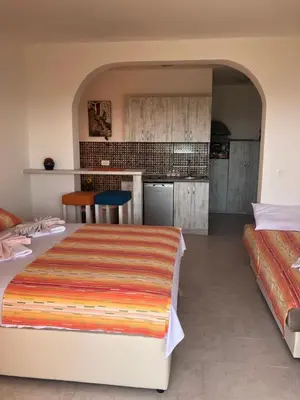 a bedroom with two beds and a kitchen at Vila POGLED in Bar